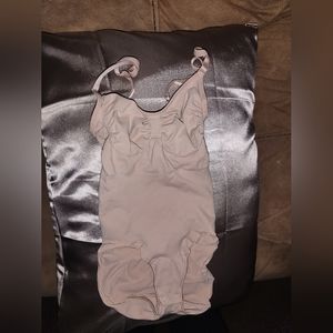 Skims brand size L/XL shapewear with snap bottom.